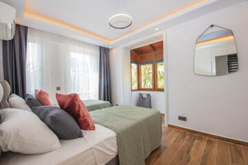 Twin beds, large fitted wardrobes, balcony accessible through french windows.